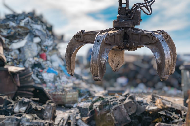Crane claw picking up garbage