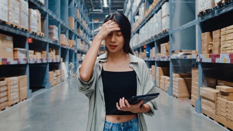 Concerned warehouse worker having problems